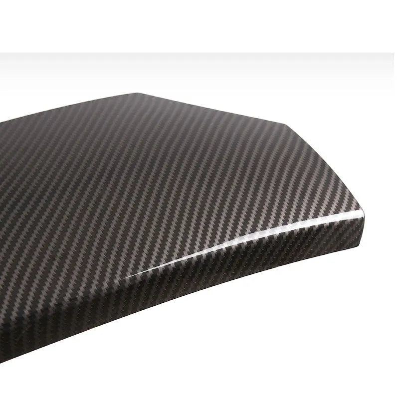 Three ABS carbon fibre pattern armrest box protective covers showing diagonal weave and shiny surface