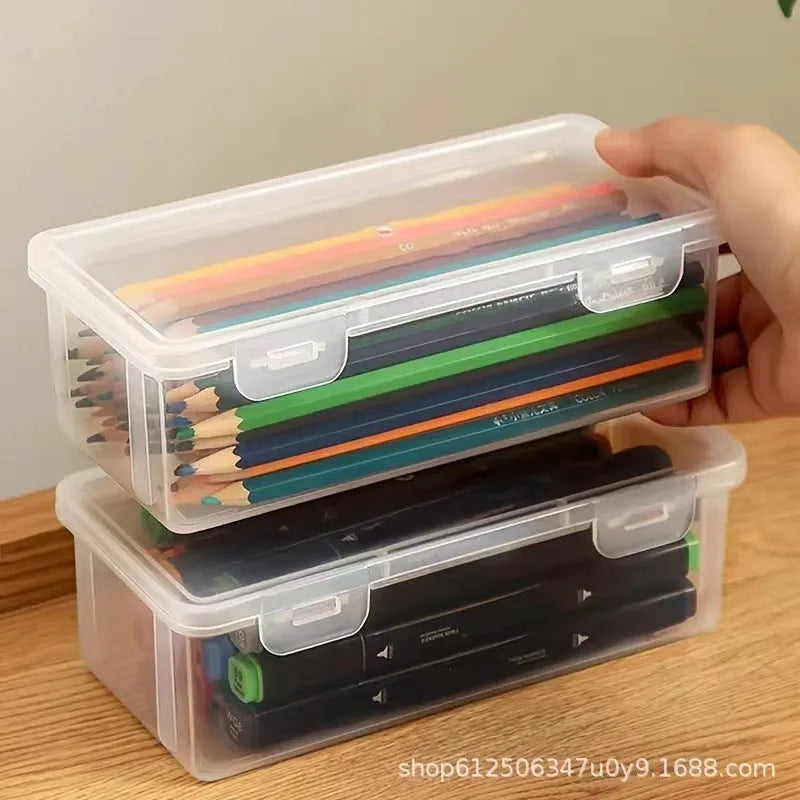 Transparent plastic pencil storage box showing organised drawing tools inside