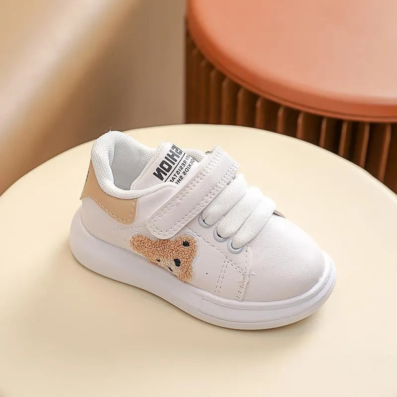 Children's black casual sports shoes with a cartoon bear design on the side, featuring an artificial leather upper and rubber sole.
