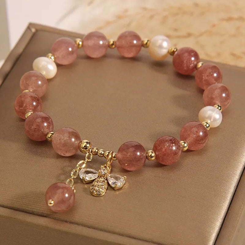 Women's bracelet with pink strawberry quartz stones, white freshwater pearls, and zircon details on an alloy chain.