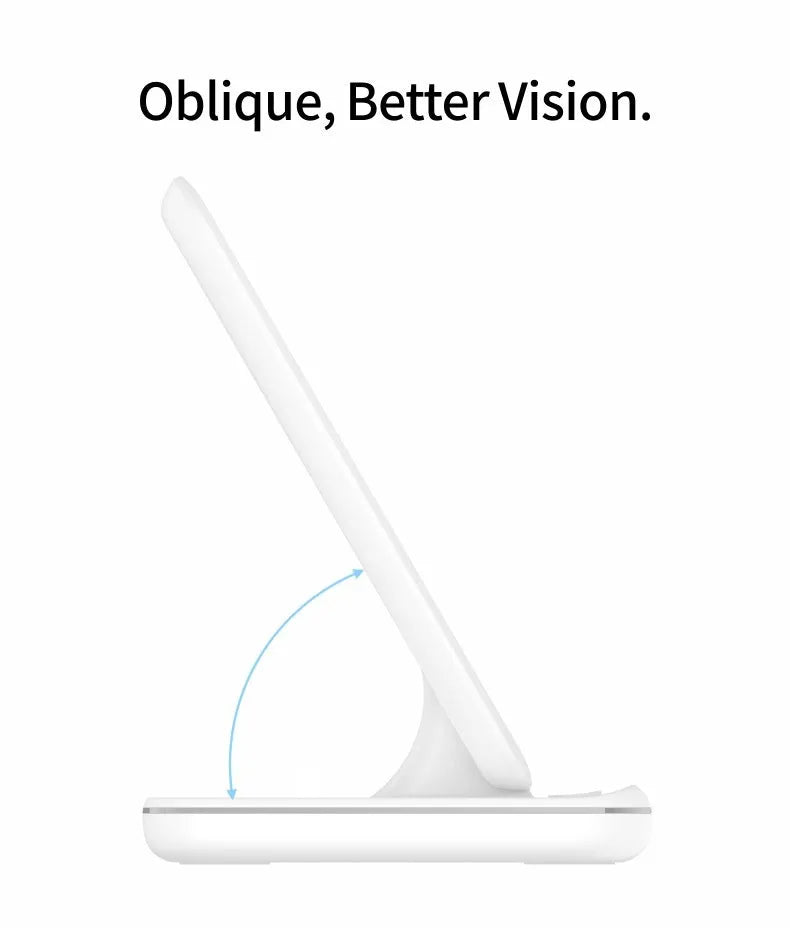 White three-in-one wireless charging stand for phone, watch, and headset on a desk.
