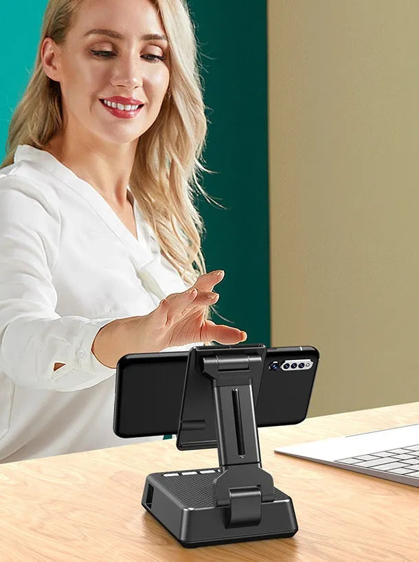 Black Bluetooth speaker phone stand with microphone for live streaming, showing phone holder and charging port