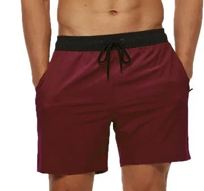 Men's blue stitching waist athletic shorts with drawstring and zipper pockets laid flat.