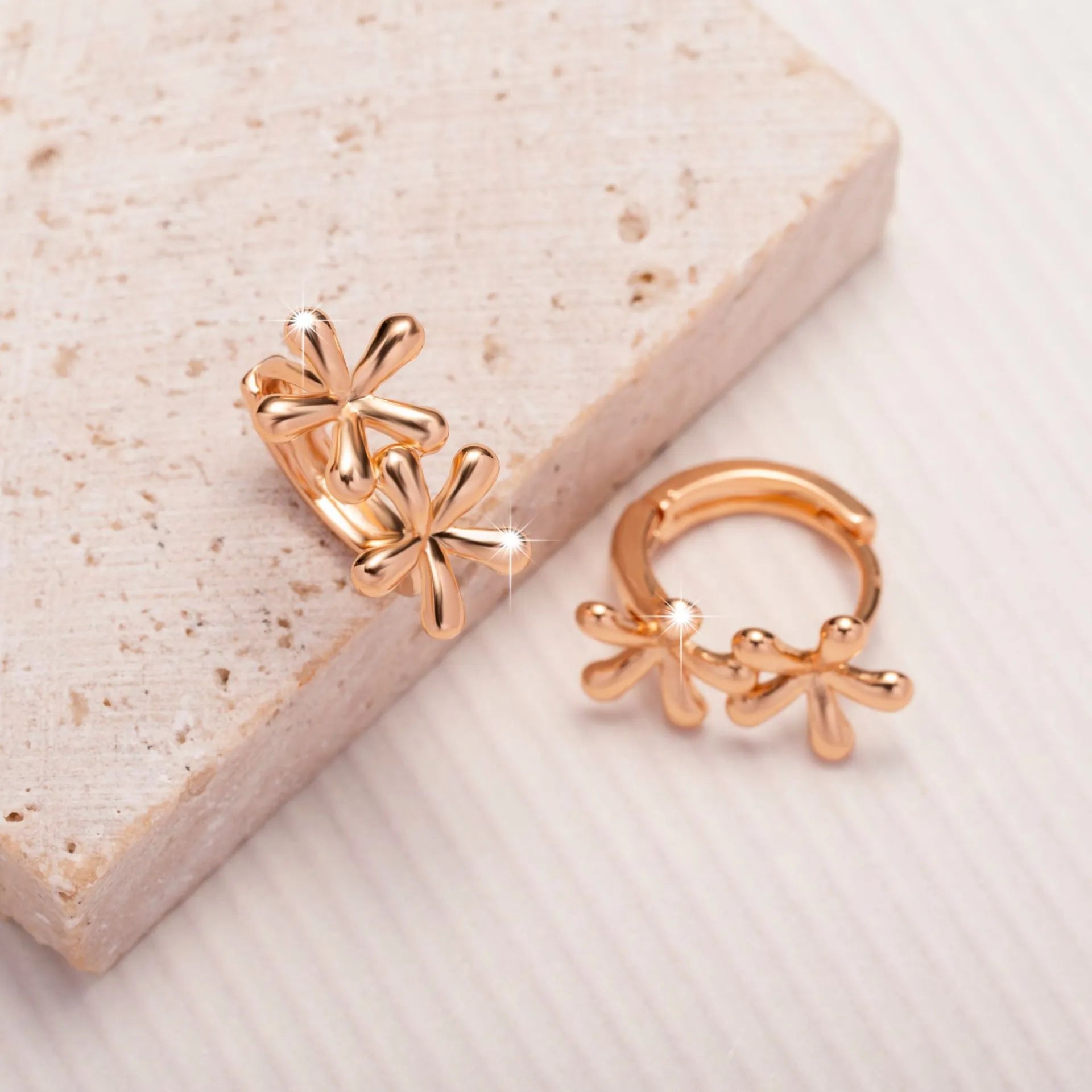 Circular rose gold earrings with a detailed waterdrop flower design for women.