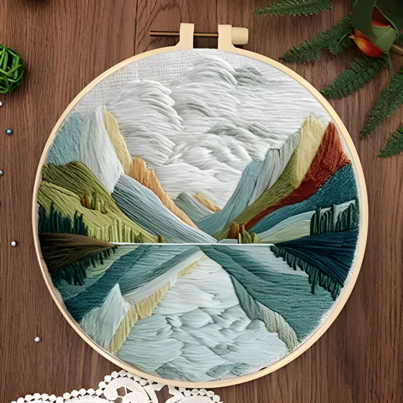Embroidery DIY kit with cotton fabric, bamboo frame, scissors, and printed landscape pattern