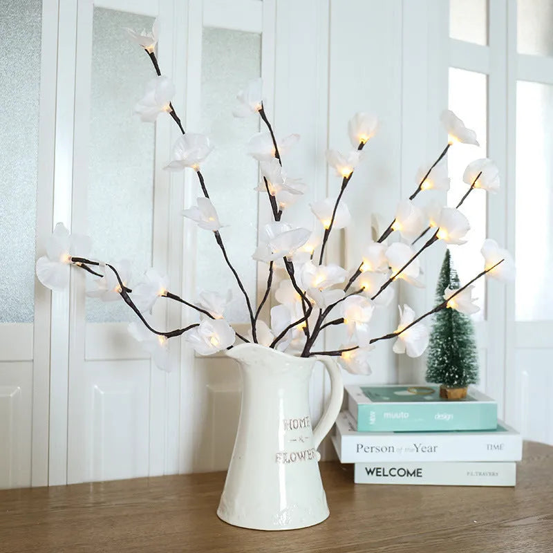 Pink LED phalaenopsis orchid branch decorative light on a table
