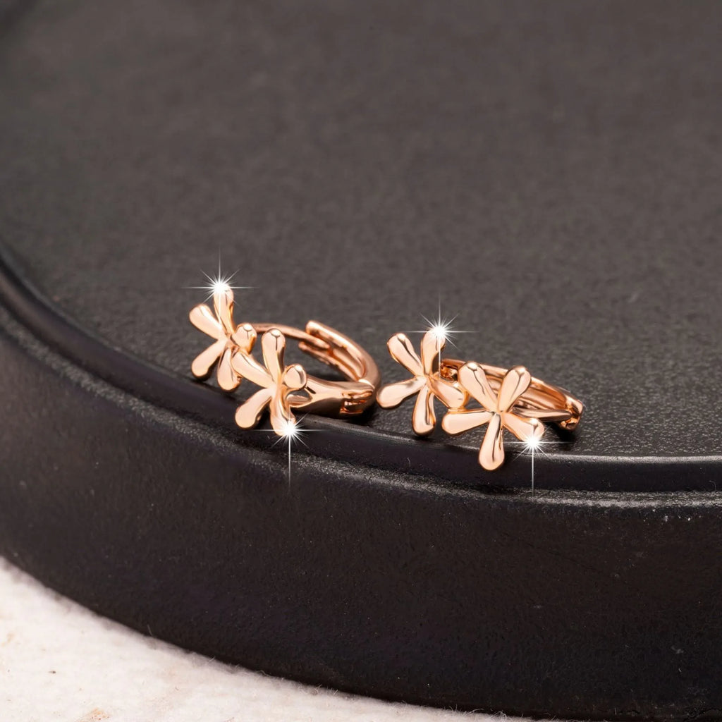 Circular rose gold earrings with a detailed waterdrop flower design for women.