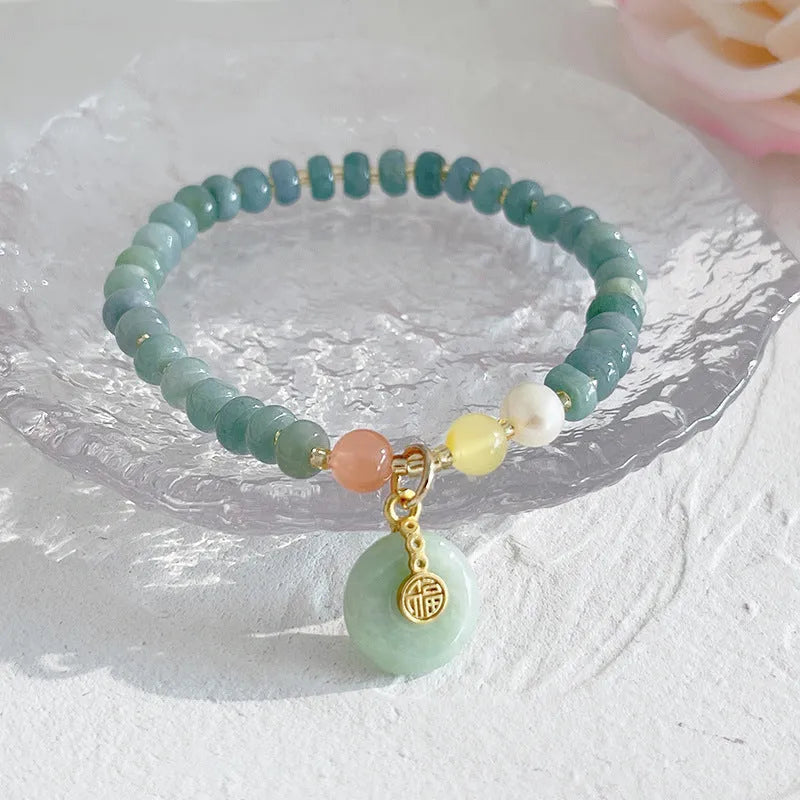 Natural blue water jade bracelet with gourd charm and peace buckle on woman's wrist