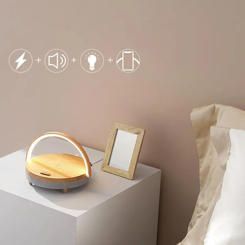 Wireless charging LED night light with Bluetooth speaker and phone holder in marble pattern finish.