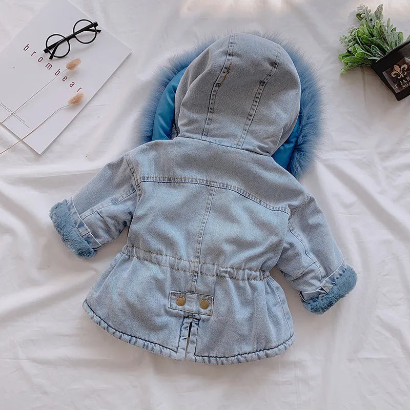 Blue denim coat for girls with a hood and plush fleece lining, shown on a hanger.