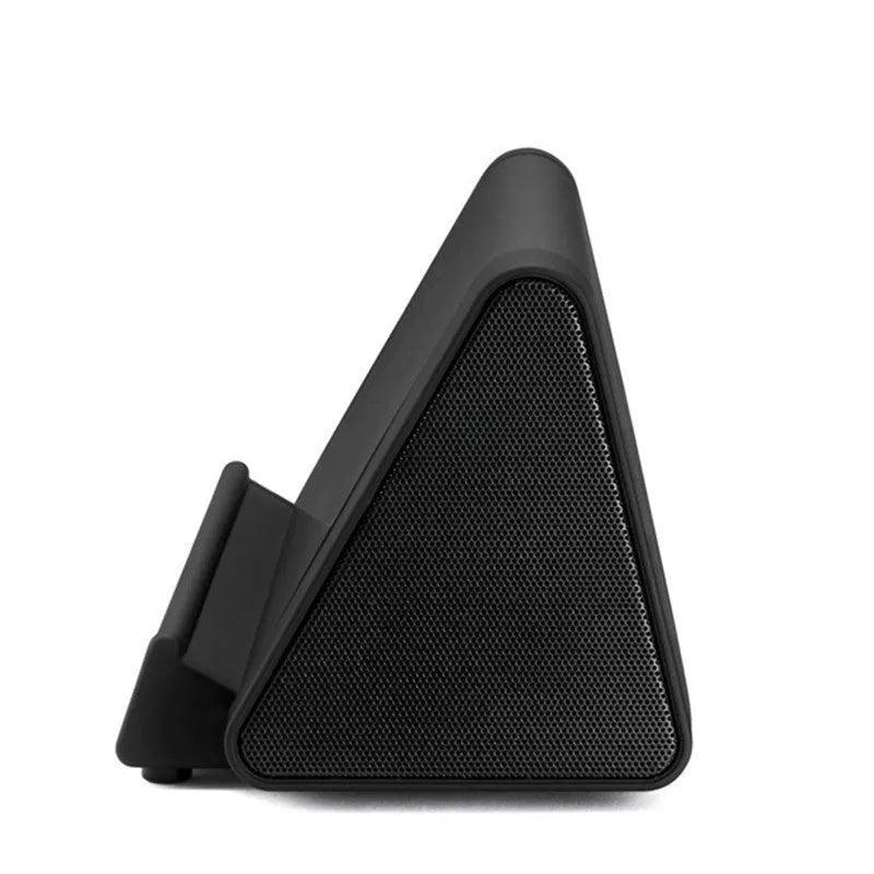 Small black and white wireless Bluetooth speaker with charging cable