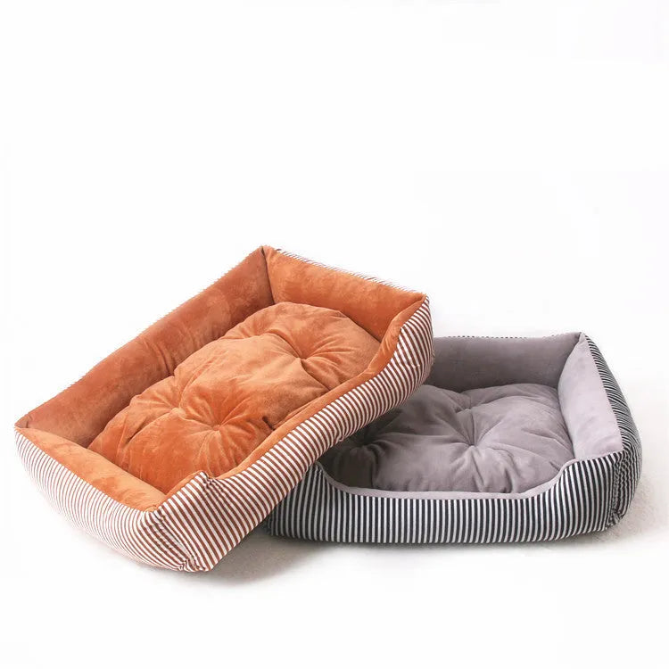 Round grey and white striped bolster dog bed on a wooden floor