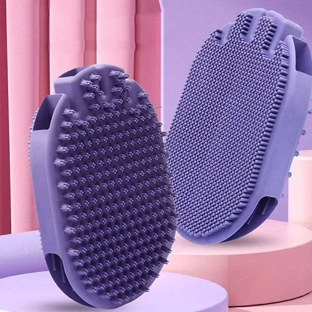 Purple dual-sided pet shampoo and massage brush with soft TPR bristles and ergonomic handle.