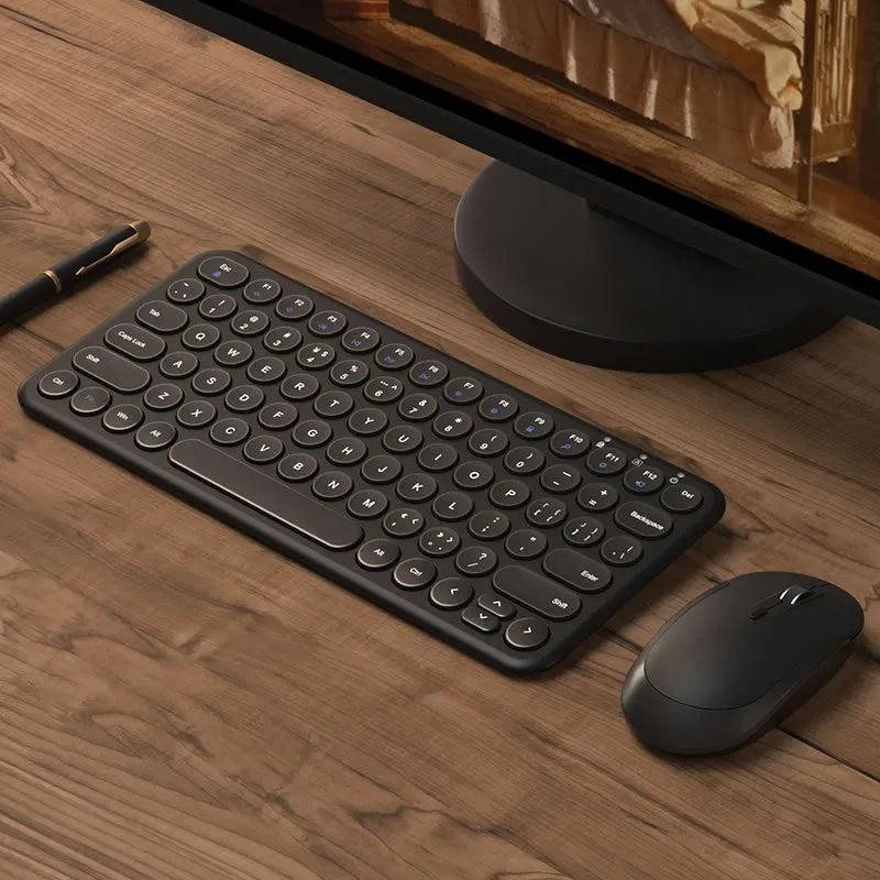 Ultra-thin white wireless keyboard and mouse set with USB receiver on a desk.