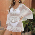 White women's beach blouse for swimming and sun protection with water soluble texture