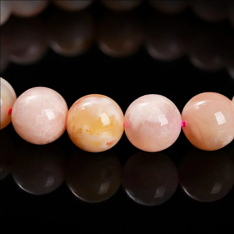 A sweet-style natural cherry agate bracelet with round geometric beads for women.