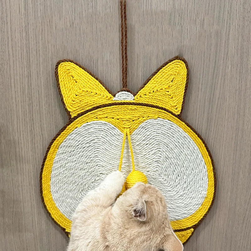 Yellow corgi-butt design sisal cat scratching pad with anti-slip base on a wooden floor.