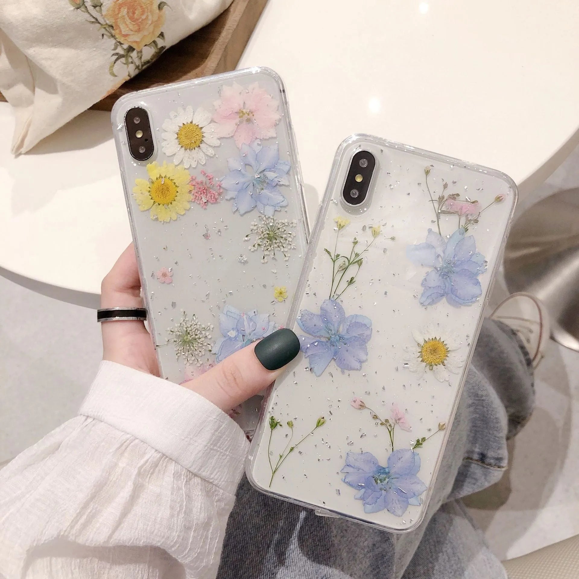 Transparent TPU phone case with real dried daisy flowers and gold glitter under clear epoxy coating