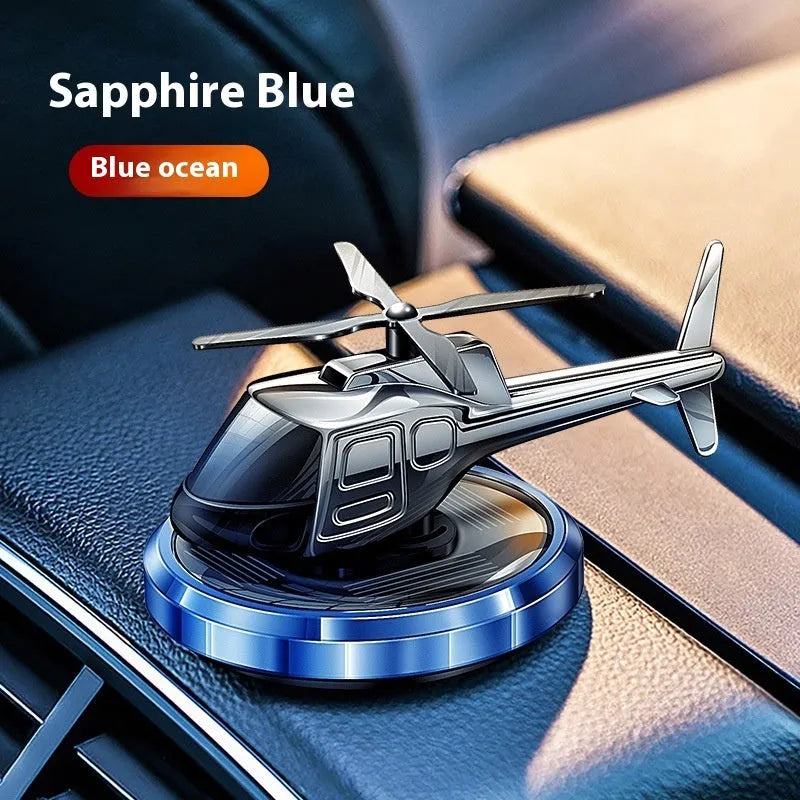 Silver metal solar-powered helicopter car ornament with rotating perfume diffuser blades.