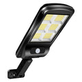 Black solar-powered outdoor motion sensor light mounted on a wall or fence post.