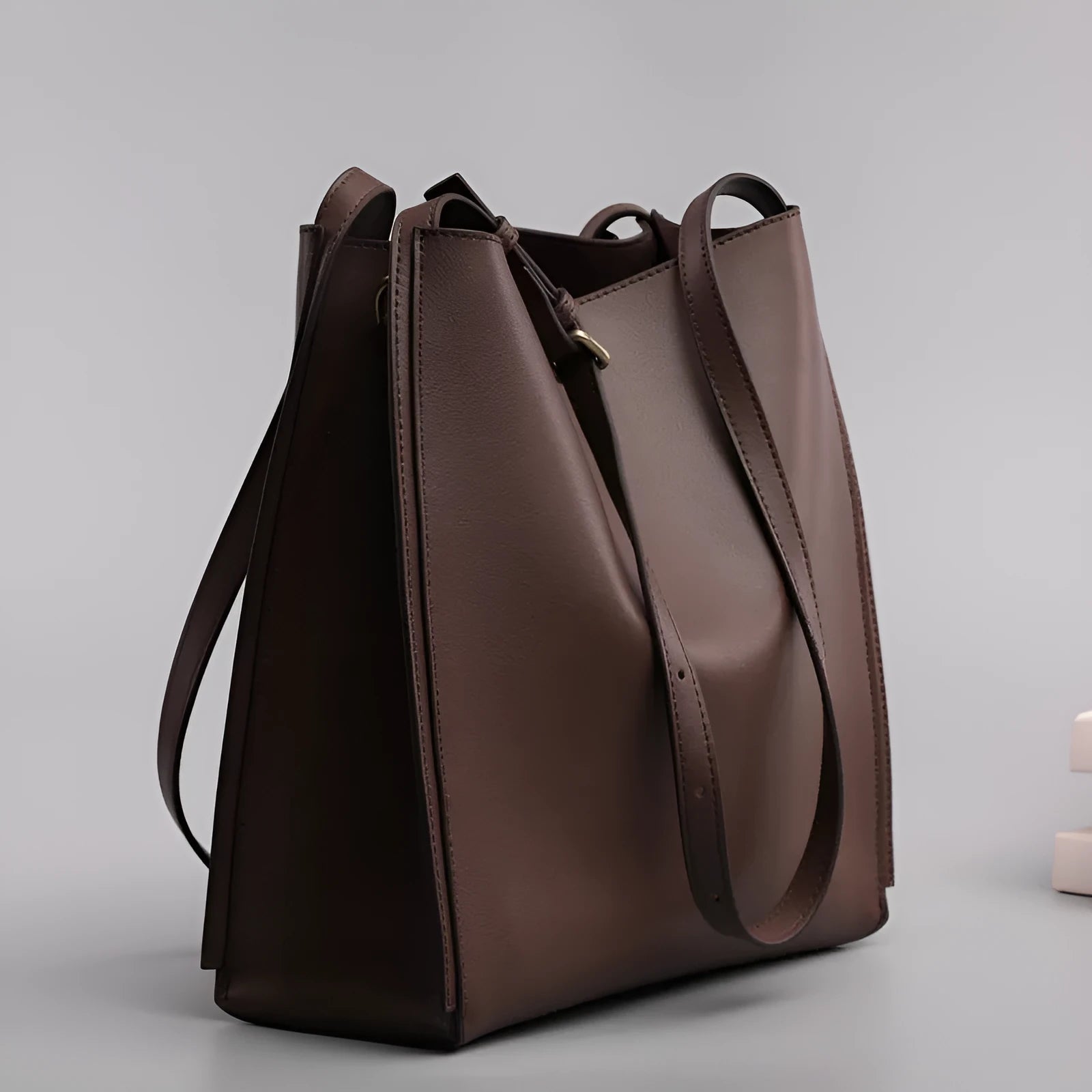 Brown genuine leather women's bucket bag with double shoulder straps and multiple internal organisers