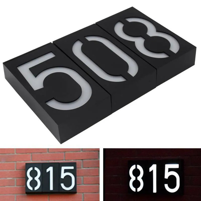 Solar powered illuminated house number light with white LEDs mounted on exterior wall
