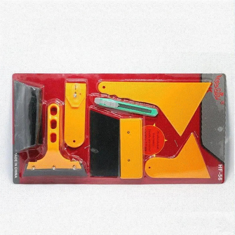 Seven-piece car foil tool set including scrapers, knives, tendon scraper, and pressing block on a table.