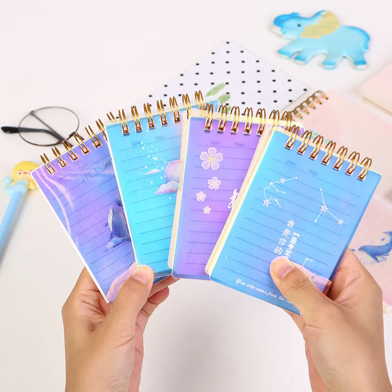 A7 spiral-bound pocket notebook with PP cover, shown in one of four colour series, open to show 80g paper and spiral binding.