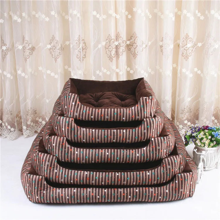 Round grey and white striped bolster dog bed on a wooden floor