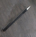 Traditional Chinese student writing brush with Jianhao nib on steel pipe barrel measuring 23cm length