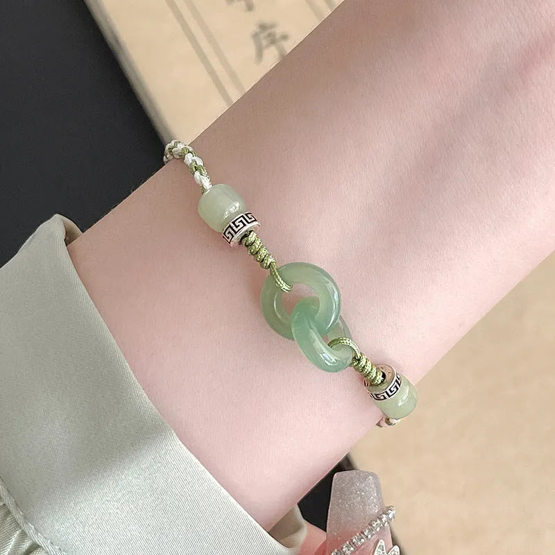 Women's copper bracelet with jade peace buckle and ethnic woven double-ring strap.