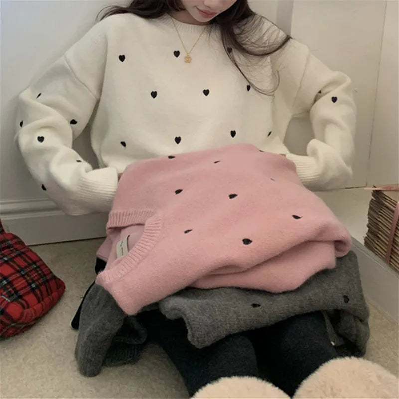 Women's loose long sleeve pink sweater with embroidered love pattern detail