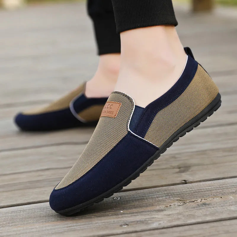 Men's grey and khaki canvas slip-on board shoes with round toe and rubber sole.