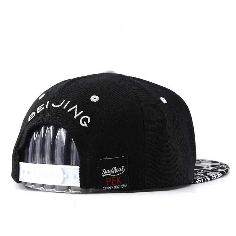 Cotton baseball cap with embroidered lettering on the front, shown in black and white colours
