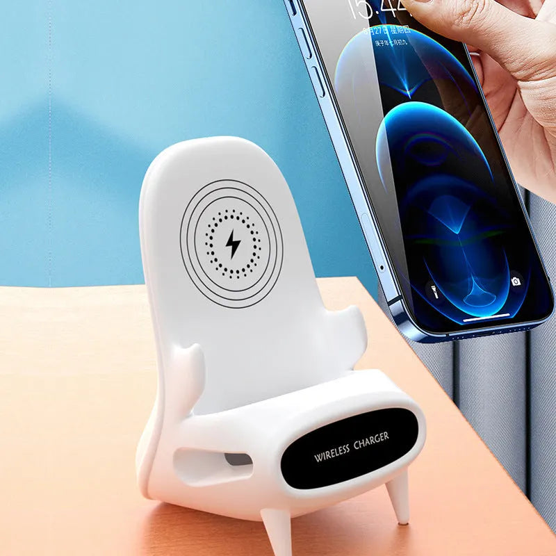 White mini chair shaped wireless charging stand holding a mobile phone at an angle