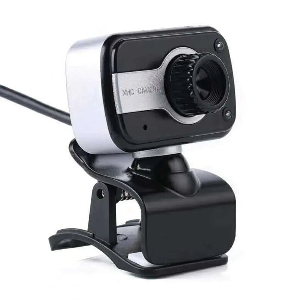 Blue mini USB webcam with a 360-degree rotating head on a desk next to a laptop.