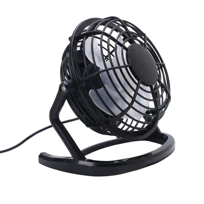Mini portable USB desk fan with adjustable angle in black colour beside laptop