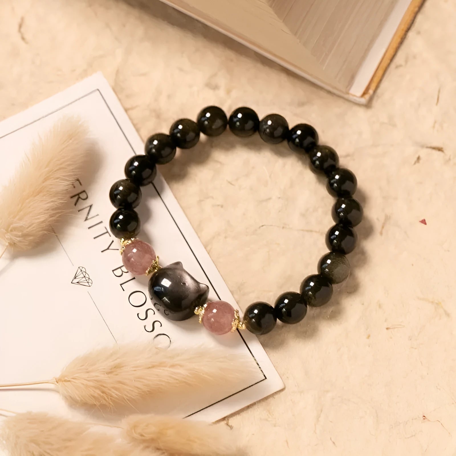 Black obsidian bracelet with 8mm beads and silver cat charms on stretch cord