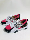Women's black suede casual sneakers with a wedge heel and round toe on a plain background.