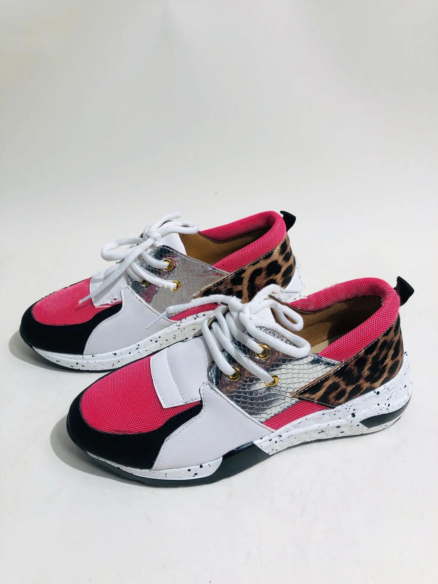 Women's black suede casual sneakers with a wedge heel and round toe on a plain background.