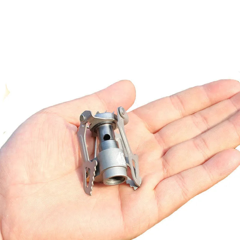 Portable propane gas camping stove with a one-piece furnace structure.