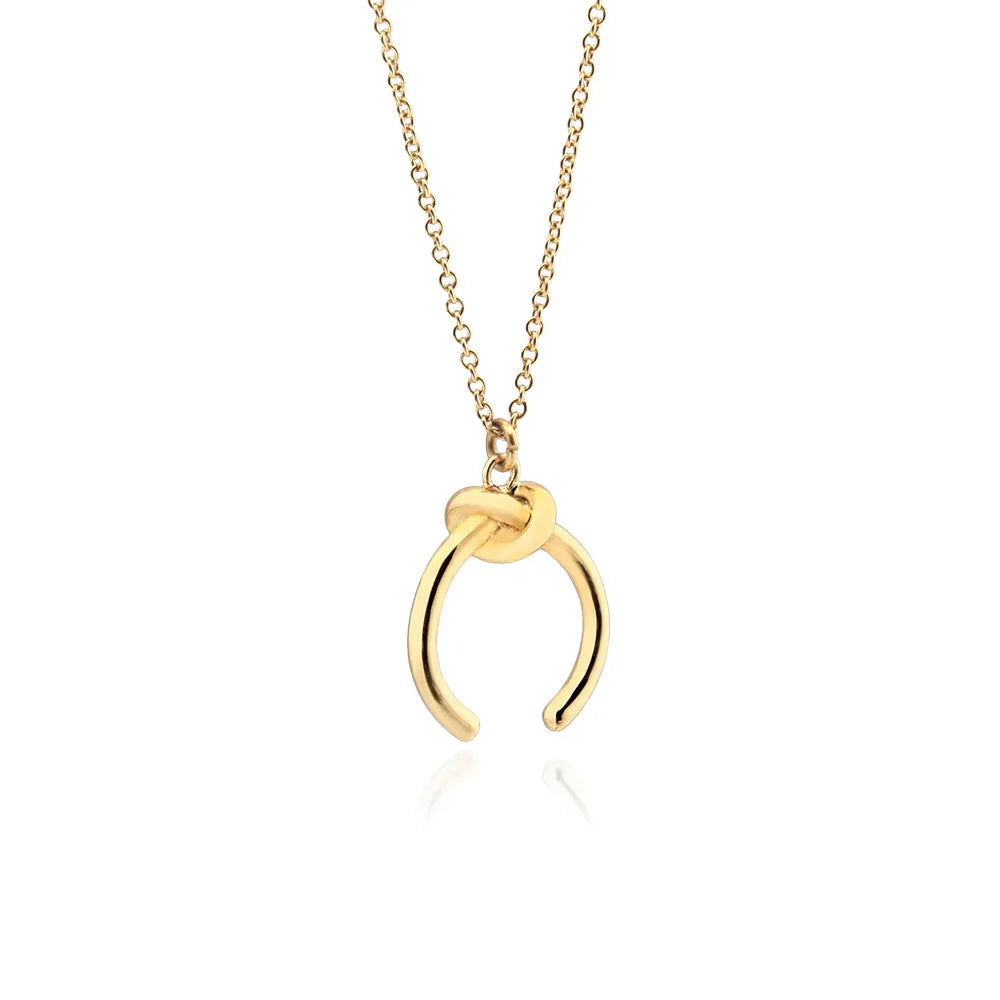 Geometric pendant necklace on an adjustable cross chain, shown in gold and silver electroplated finishes.