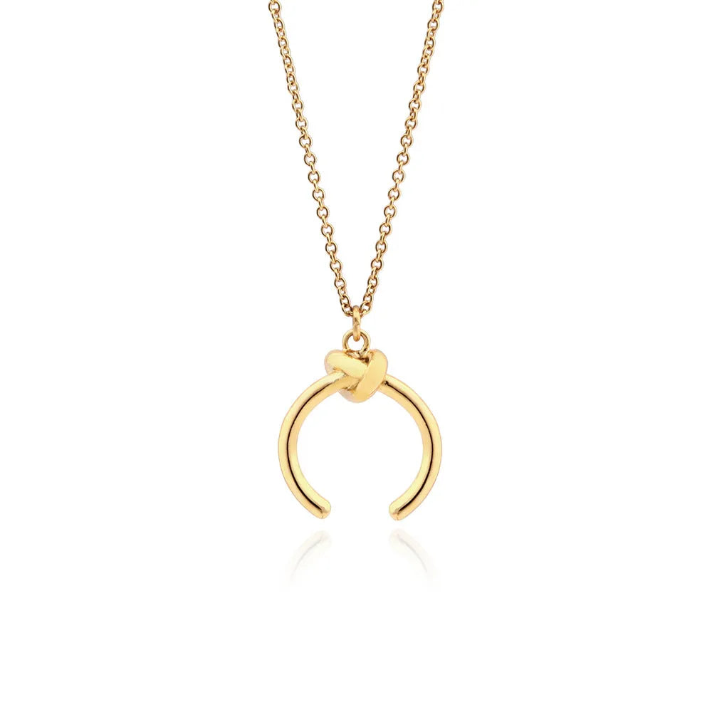 Geometric pendant necklace on an adjustable cross chain, shown in gold and silver electroplated finishes.