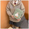 Blue cotton tablet case with embroidered cartoon duck design and a zipper, shown next to a green version.