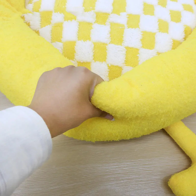 A plush, thick nest-style dog bed for small to medium sized pets, shown in yellow, pink, or black.