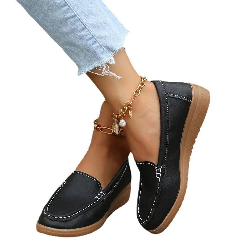 Women's flat loafer in PU leather with round toe and car suture detail, shown in multiple colours.