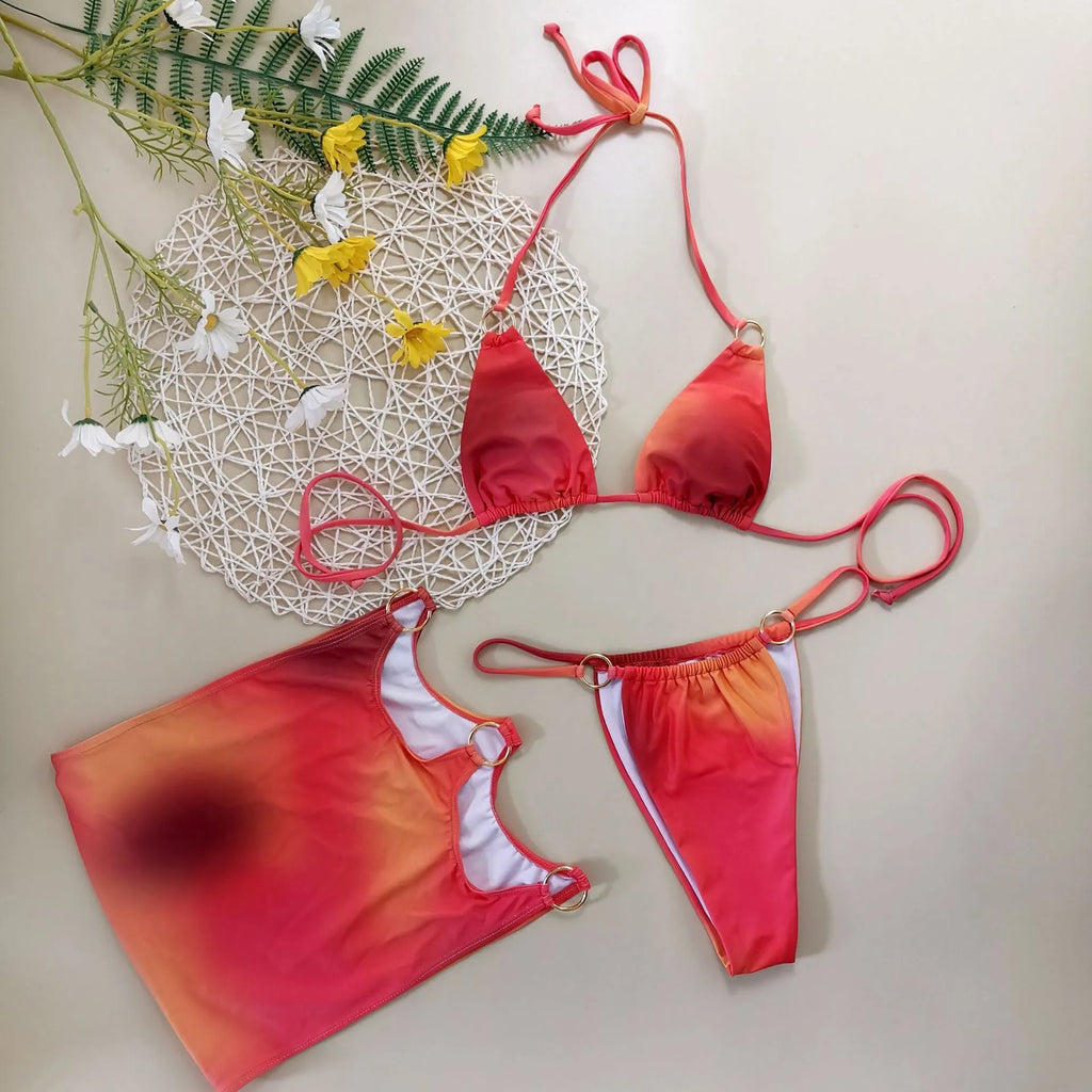 Tie-dye solid colour three-piece halter bikini swimsuit set with skirt on a mannequin.