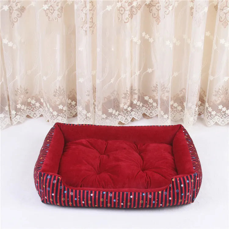 Round grey and white striped bolster dog bed on a wooden floor