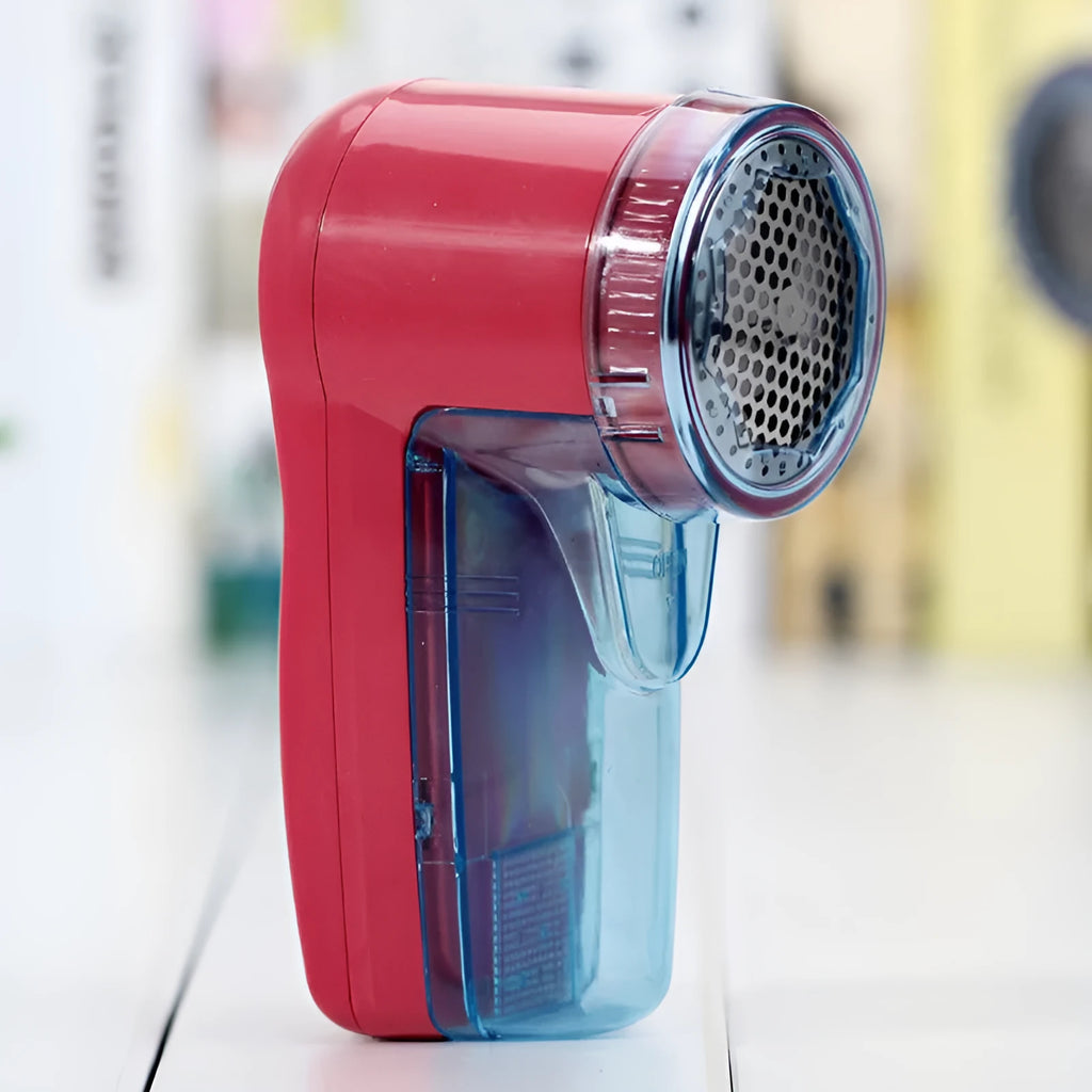 Portable electric clothes lint remover and pill shaver unit with compact white body.