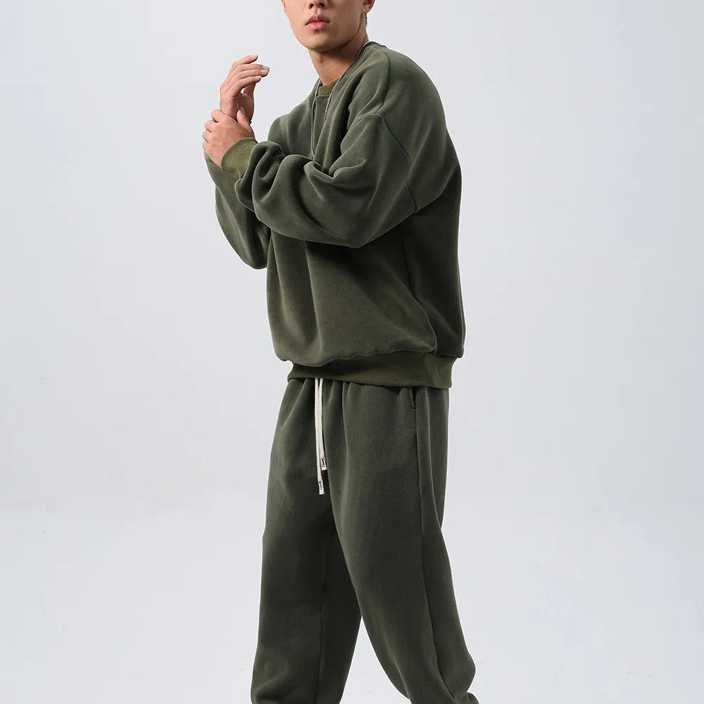 Men's polar fleece sports suit showing long-sleeved top and padded trousers in light grey colour